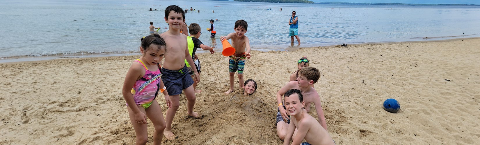 a group of kids playing in the sand