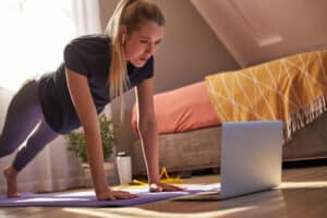 a woman doing push ups on a yoga mat