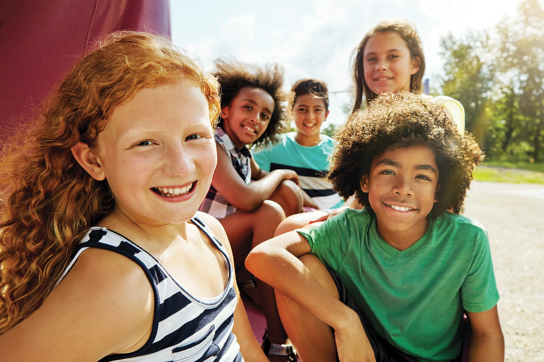 a group of kids smiling for a photo